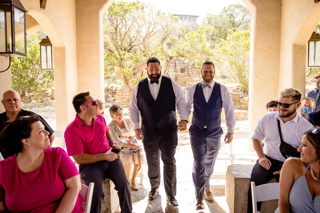 two grooms walk down the aisle for their small elopement